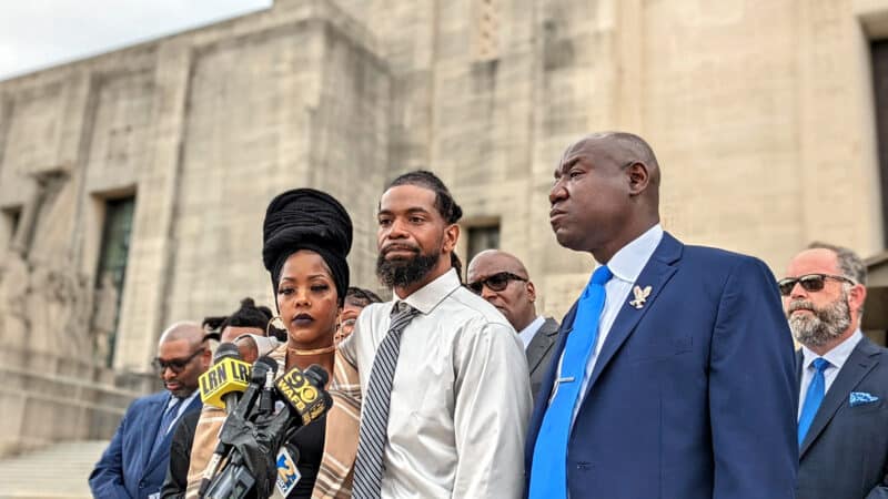 Nancy Davis (left) stands with her partner, Shedric Cole (center), and lawyer, Ben Crump (right), in front of the Louisiana legislature, Aug. 26, 2022.