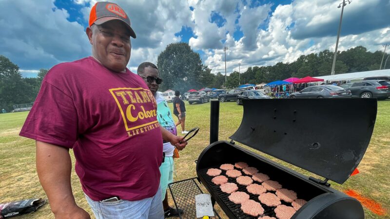 Jeff Flanigan, 59, helps grill hamburgers for the 800 people celebrating Colony Day in Colony, Alabama, Aug. 6, 2022.