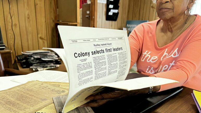 Gwendolyn Purifoy, Colony, Alabama town clerk, flips through archival documents about the town's history, Aug. 17, 2022.