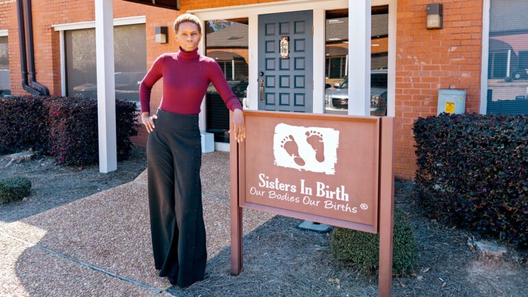 Getty Israel stands outside Sisters in Birth, the clinc she runs in Jackson, Mississippi.