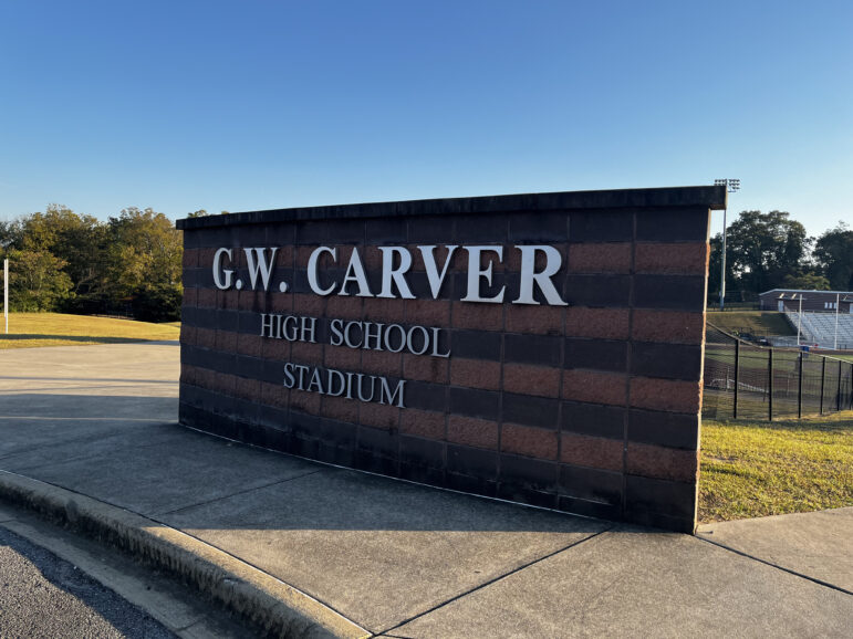 A sign outside Carver High School reads "G.W. Carver High School Stadium"