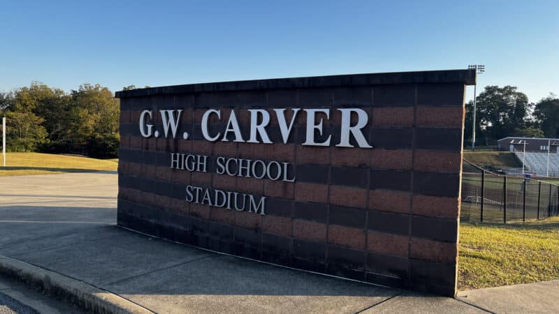 A sign outside Carver High School reads "G.W. Carver High School Stadium"