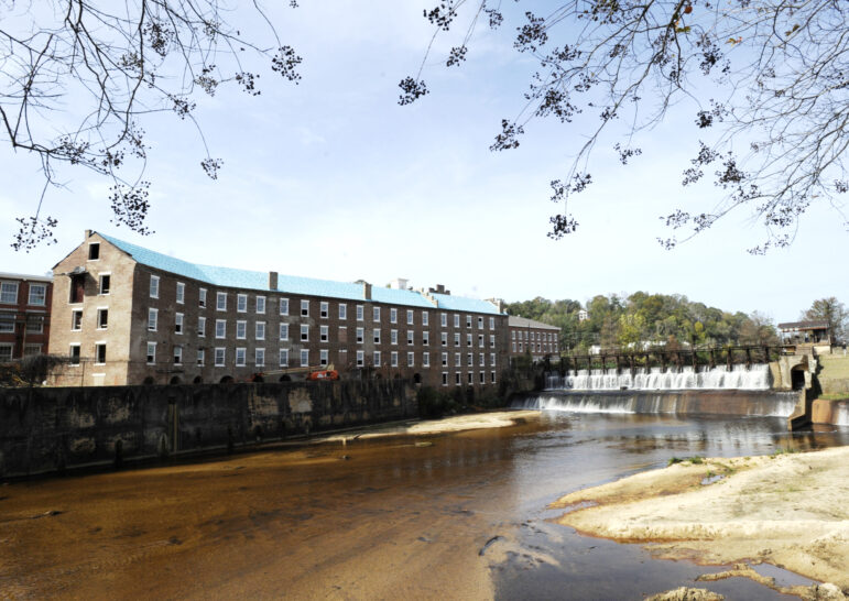 A once-abandoned cotton gin factory that is being renovated into apartments stands beside Autauga Creek in Prattville, Ala.