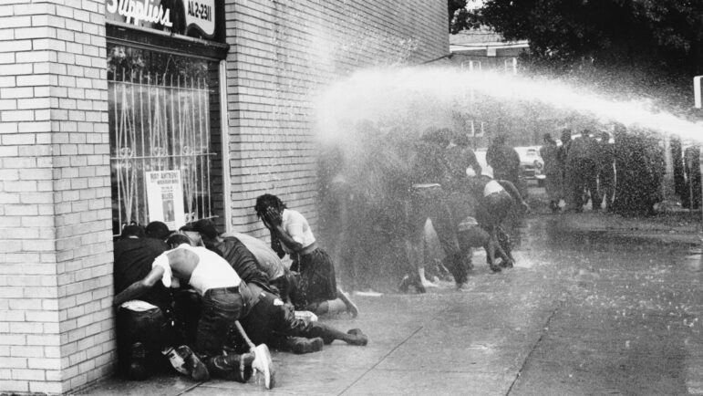 BIRMINGHAM, AL - MAY 1963: A water cannon is used on young African Americans during a protest against segregation, organized by Reverend Dr. Martin Luther King Jr. and Reverend Fred Shuttlesworth, in Birmingham, Alabama, May 1963. (Photo by Frank Rockstroh/Michael Ochs Archives/Getty Images)