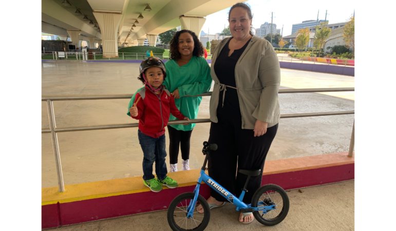 Brooke Chickering stands with her two kids, 3-year-old Asa and 9-year-old Carmen, at the City Walk's skate rink. They try to come a few times a week.