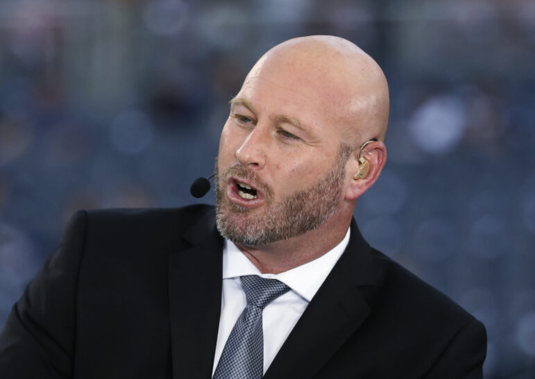 Trent Dilfer speaks into a headset microphone during an appearance on ESPN.