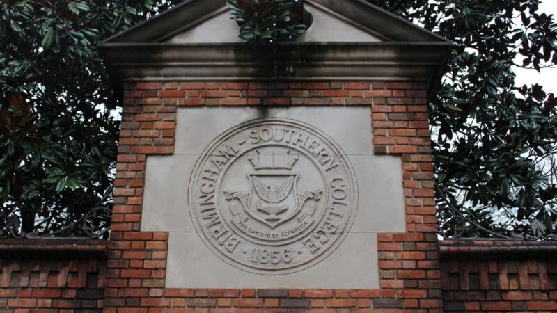 A sign on the Birmingham Southern College campus shows the school's seal and reads "Birmingham Southern College 1856."
