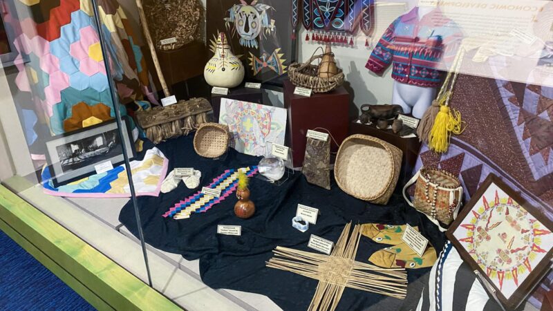 A mix of modern and historical objects line display case at the Poarch Band of Creek Indians museum in Atmore, Alabama, Nov. 28, 2022.