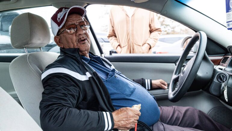 Rufus Coleman, of Nelton, Mississippi, waits in line to get his monthly food box on Dec. 8, 2022, at the Saint Luke Food Pantry in Tupelo, Mississippi. 