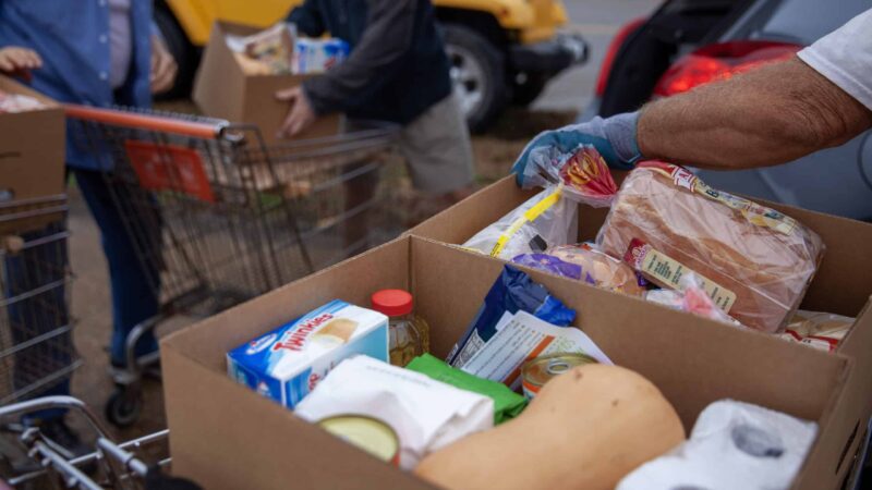 Volunteers prepare to load boxes of food into cars on Dec. 8, 2022, at the Saint Luke Food Pantry in Tupelo, Mississippi.