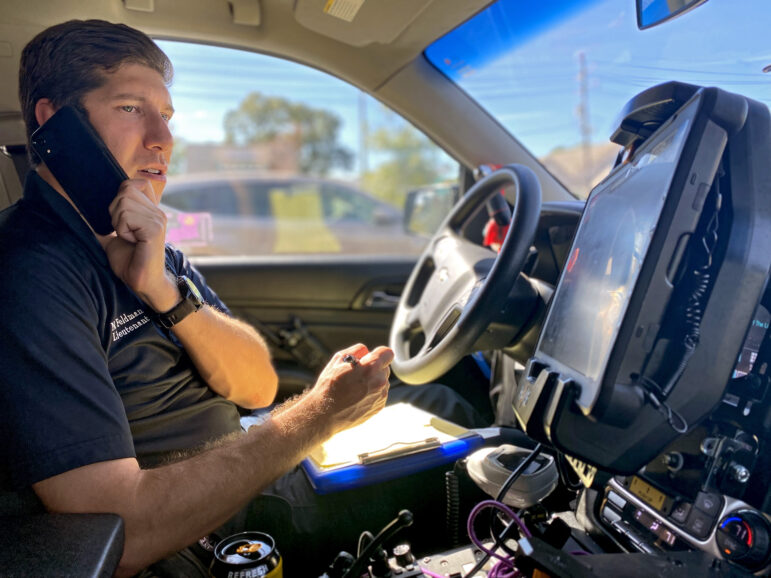 An EMS dispatcher answers a phone.