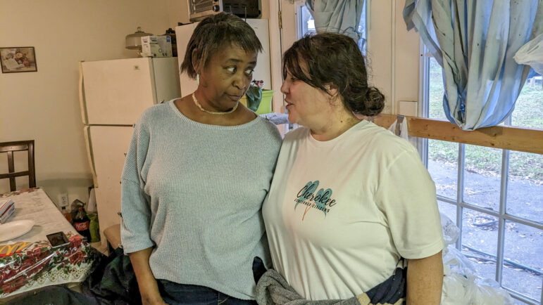 Cherokee Concerned Citizens organizers Jennifer Crosslin, right, and Barbara Irvin, left, embrace during a holiday event in the Cherokee Forest subdivision in Pascagoula, Mississippi, December 17, 2022.