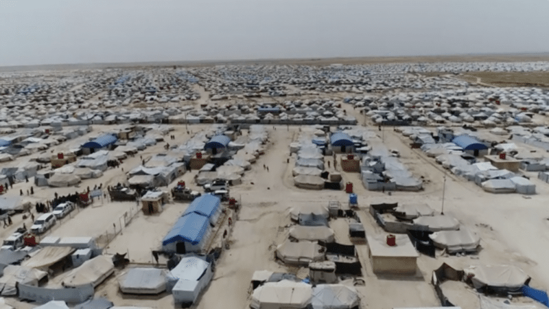 An aerial view of a detention camp in northeastern Syria shows a wide expanse of tents and shelters in the desert.