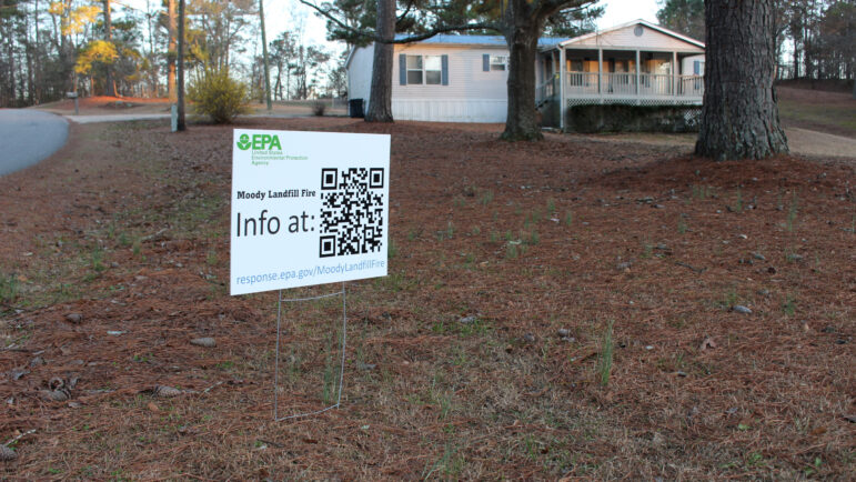 An EPA sign with a QR code is placed in a home's front yard on Annie Lee Road.