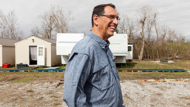 Matthew Chouest, pastor of the First Baptist Church of Golden Meadow, stands on a piece of his family property that he gave to the Amish aid group C.A.R.E. to use while they help the region recover after Hurricane Ida, Jan. 18, 2023.