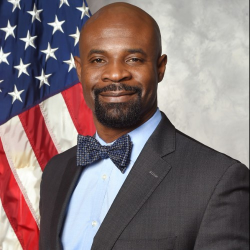 Headshot of James Dorsey in front of an American flag.