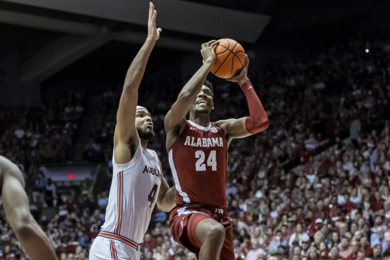 Alabama forward Brandon Miller (24) works past Auburn forward Johni Broome (4) for a shot during the first half of an NCAA college basketball game, Wednesday, March 1, 2023, in Tuscaloosa, Alabama. 