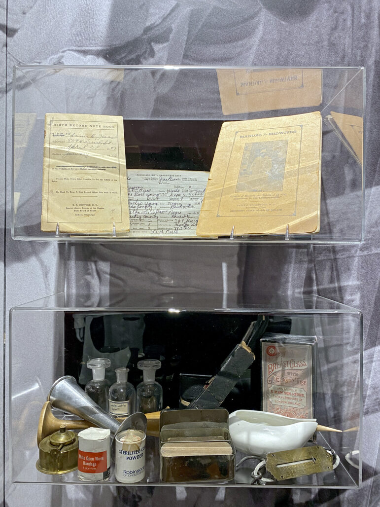 A display at the Smith Robertson Museum and Cultural Center's Scott Ford House Permanent Exhibit shows the tools of the trade for granny midwives on Feb. 11, 2023. They kept records of live births, and in their birthing kits, they carried medicine, tools and guidebooks for deliveries.