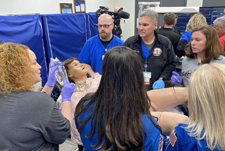 Two teams work in tandem to stabilize Victoria and keep her baby ‘warm” once she’s given birth during a STORK training simulation at UMMC, Feb. 16, 2023.