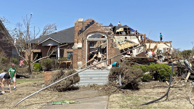 A group of men work to clear out damage from Chapel of the Cross Episcopal Church in Rolling Fork, Mississippi, on March 26, 2023.