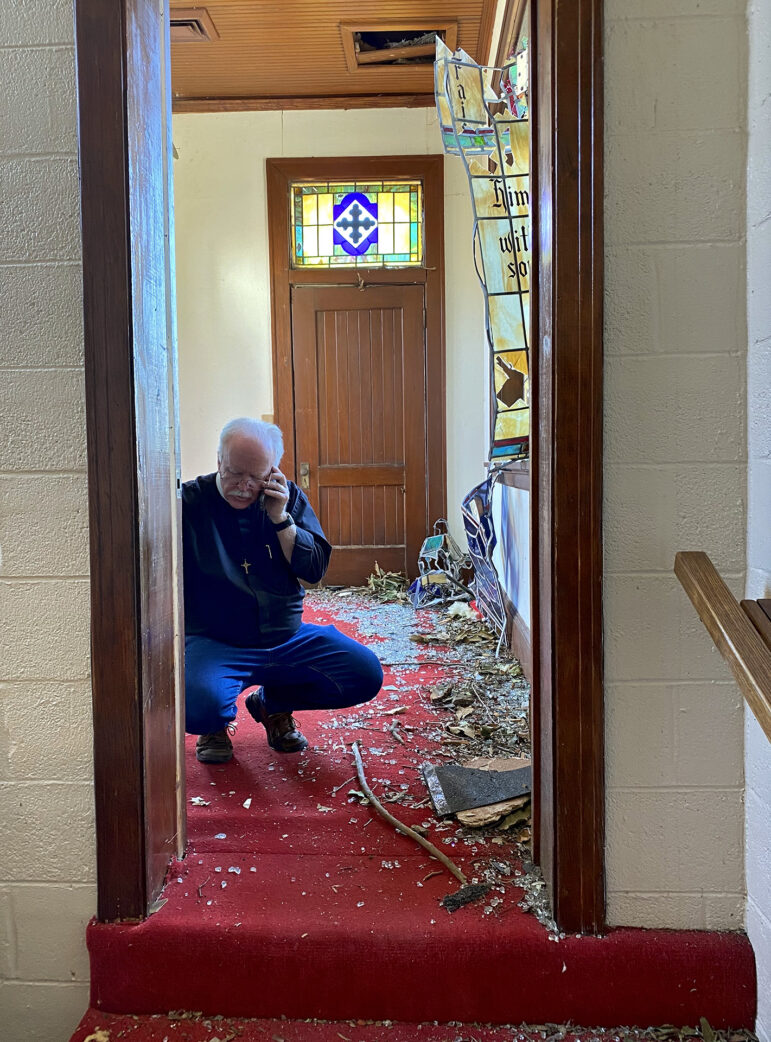 Father Greg Proctor, a priest who has been the rector Chapel of the Cross Episcopal Church in Rolling Fork, Mississippi, for 12 years, surveys damage in the church’s sanctuary on March 26, 2023. 