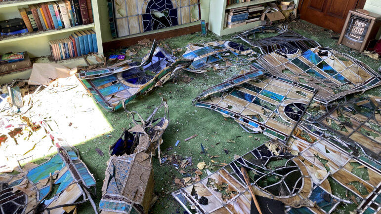 Shattered panels of stained glass lay on the floor of a room in Chapel of the Cross Episcopal Church in Rolling Fork, Mississippi, on March 26, 2023.