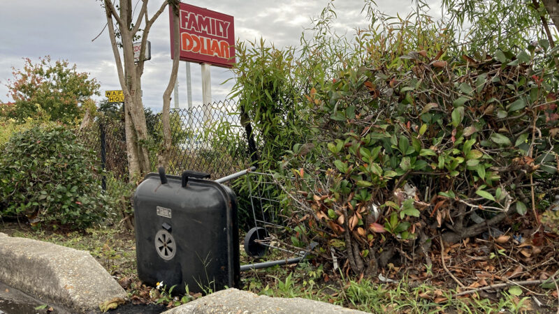 Trash, including an overturned grill, litter the outskirts of a Family Dollar parking lot in New Orleans, Louisiana.