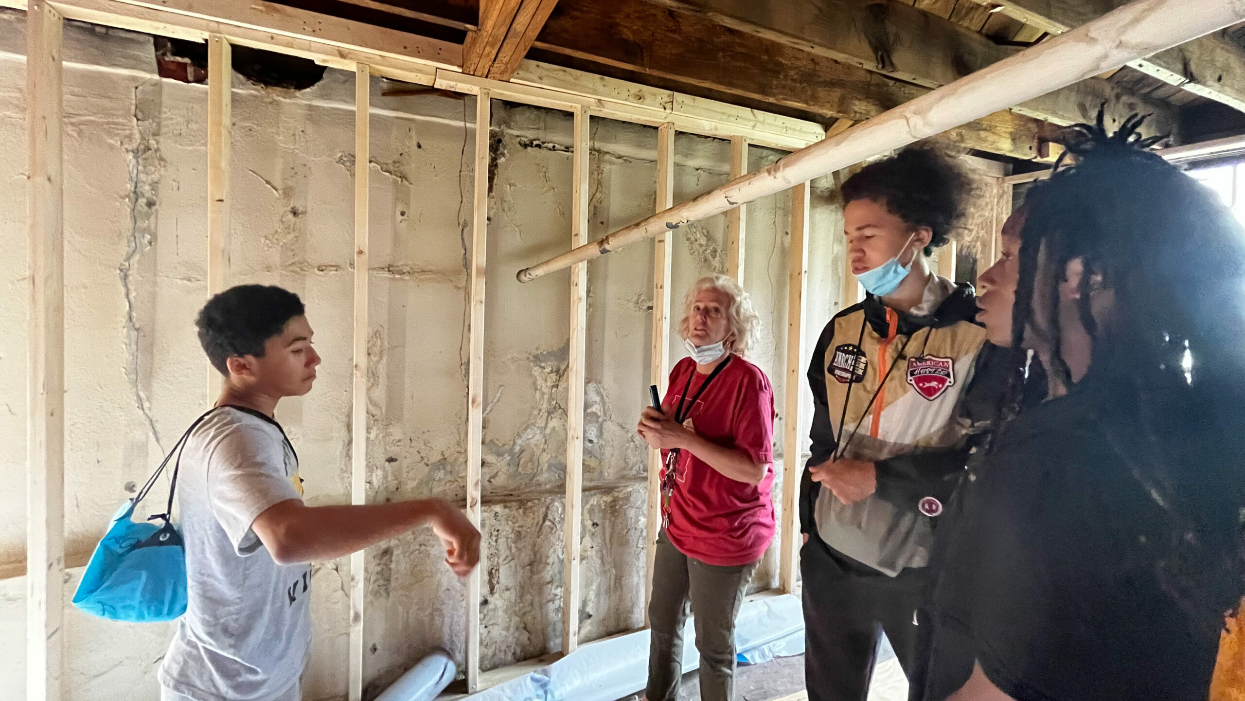 students stand in unfinished house