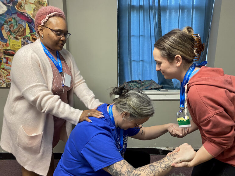 Miracle Barnes (left) acts as a doula for Amanda Rutledge (center) and Sarah Moyer (right) during a BirthWell Partners training exercise in Birmingham, Alabama, on April 23, 2023.