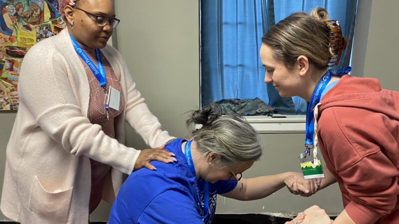 Miracle Barnes (left) acts as a doula for Amanda Rutledge (center) and Sarah Moyer (right) during a BirthWell Partners training exercise in Birmingham, Alabama, on April 23, 2023.