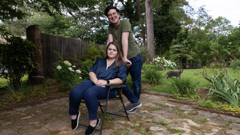 Meghan and Will Taylor, and their cat, hang out in the backyard of their new home on Wednesday, May 31, 2023, in Gardendale, Alabama.