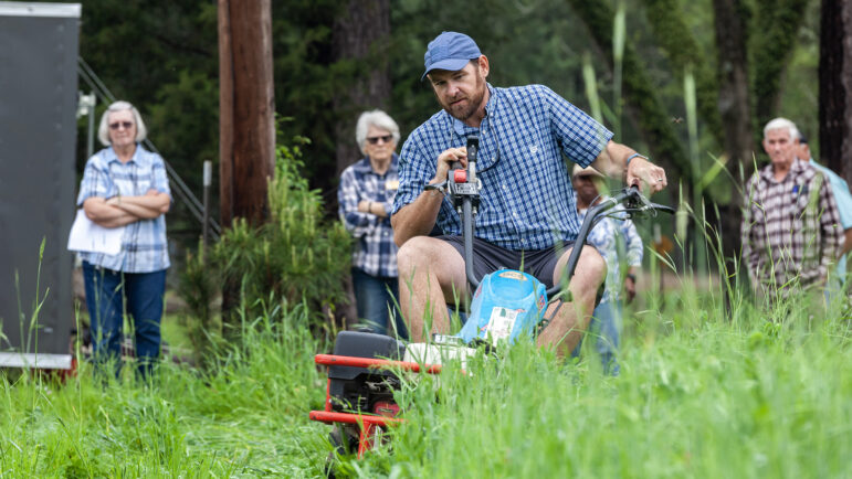 Corey Kichler, an agricultural engineer with the United States Department of Agriculture, demonstrates a no-till farming tool called a roller crimper on April 3, 2023, at the DeLaTerre Permaculture Farm in Eros, Louisiana.