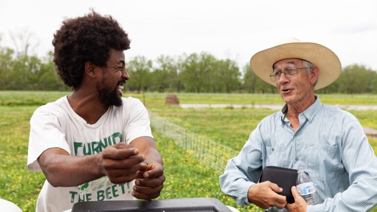 Myles Gaines (left) and John Miers chat after a series of presentations on climate friendly agriculture at Jubilee Justice on Inglewood Farm on April 4, 2023, in Alexandria, Louisiana.