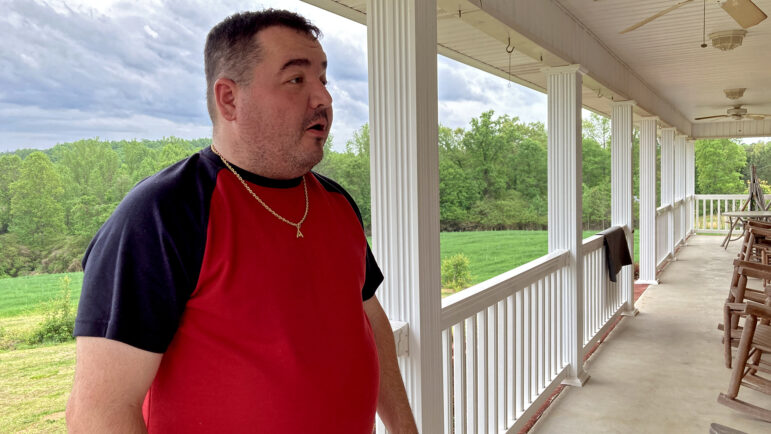 Jason Clayton stands on the porch of his home in Lookout Mountain, Alabama, on April 21, 2023.