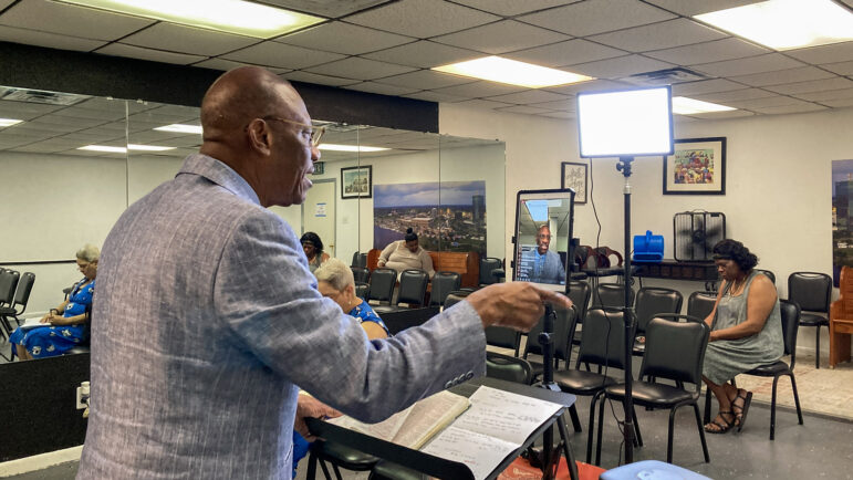 Pastor Mike Robinson live streams his sermon during a service at The Breath of Life Praise and Worship Center in Lake Charles, Louisiana on July 16, 2023.
