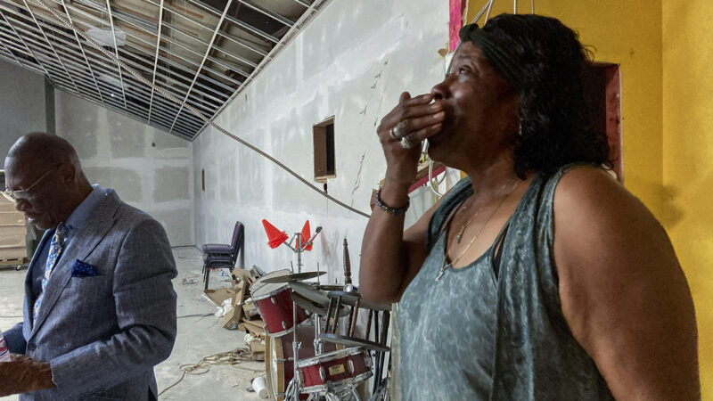 Zina Siverand (right) reacts to the latest repair updates at The Breath of Life Praise and Worship Center in Lake Charles, Louisiana, during a tour with pastor Mike Robinson on July 16, 2023.