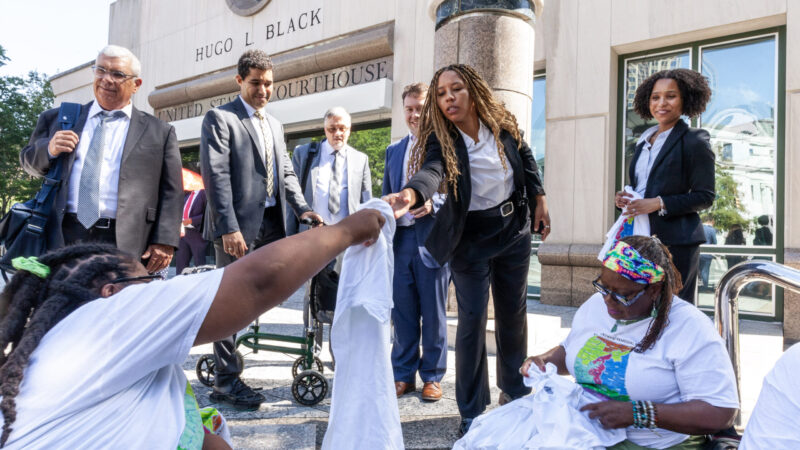 Plaintiffs in a high-profile redistricting case hand t-shirts to a group of their lawyers after a hearing on Monday, August 14, 2023, in Birmingham, Alabama.