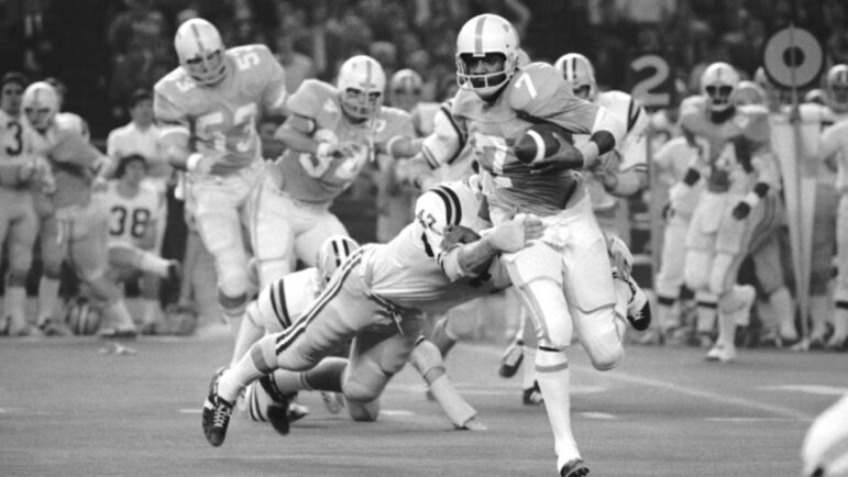 In this file photo, Condredge Holloway, Tennessee quarterback, breaks away from Frank Racine (17), LSU back, to go for a touchdown in the second quarter of the Astro-Bluebonnet game in Houston, Dec. 30, 1972.