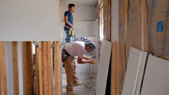 Construction workers prepare to hang drywall in Annie Burnett’s partially-rebuilt home in Silver City, Mississippi, on Sept. 20, 2023.