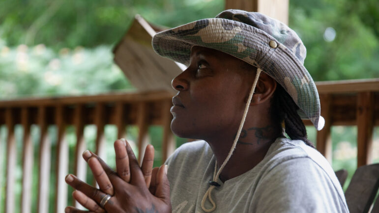 Dolabriel Curry-Hurst listens to her wife talk about the impact of an unusually large power bill on their fixed-income household on July 13, 2023, in Duncanville, Alabama.
