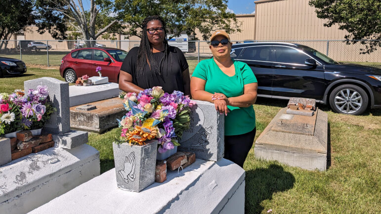 Marla Dickerson (left) and Cheryl Batiste (right) stand next to the grave of their mother, Janice Dickerson, on September 6, 2023, at the Revilletown cemetery in Plaquemine, Louisiana.