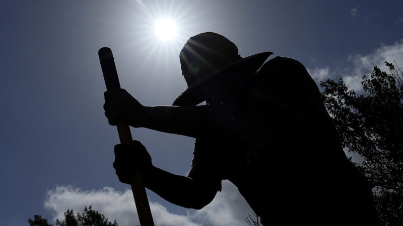 Carlos Rodriguez digs fence post holes on Tuesday, June 27, 2023, in Houston.