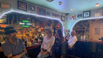 Patrons sit inside Harold and Lillian’s, a bar in Clermont Harbor, Mississippi, on Tuesday, August 29, 2023.