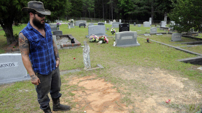 Tyler Goodson of the hit podcast "S-Town" stands at the grave in Green Pond, Alabama, of his late friend John B. McLemore,