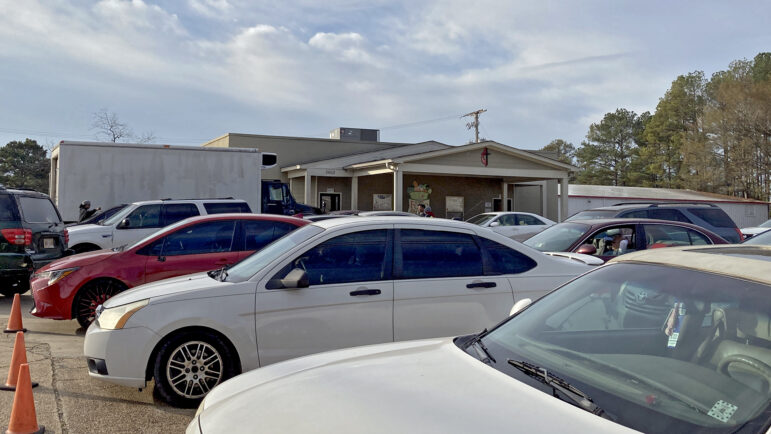 Five rows of cars wait for assistance at the St. Luke Food Pantry in Tupelo, Mississippi, on Nov. 30, 2023.