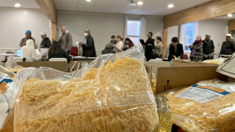 Packs of cheddar cheese top food boxes given to people seeking assistance at the Broadmoor Improvement Association’s food pantry in New Orleans, on Dec. 6, 2023.