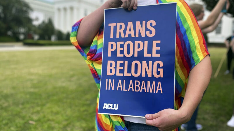A person holds up a sign reading, "Trans People Belong in Alabama," during a rally outside the Alabama Statehouse in Montgomery, Ala., on International Transgender Day of Visibility, Friday, March 31, 2023.