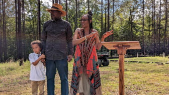 Kevin Springs stands between his wife, Teresa Ervin-Springs, and his grandson at their farm, TKO Farms, on June 19, 2023, in McCool, Mississippi.