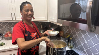 New Orleans chef Bunny Young spoons piping-hot gumbo from the pot in her home kitchen on Dec. 8, 2023.