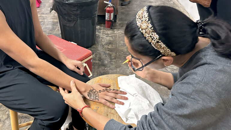 Krewe da Bhan Gras members apply and receive mehndi, a traditional Indian henna tattoo, during the group’s final dress rehearsal at the Caribbean Community Center in New Orleans on Wednesday, Jan. 24, 2024.